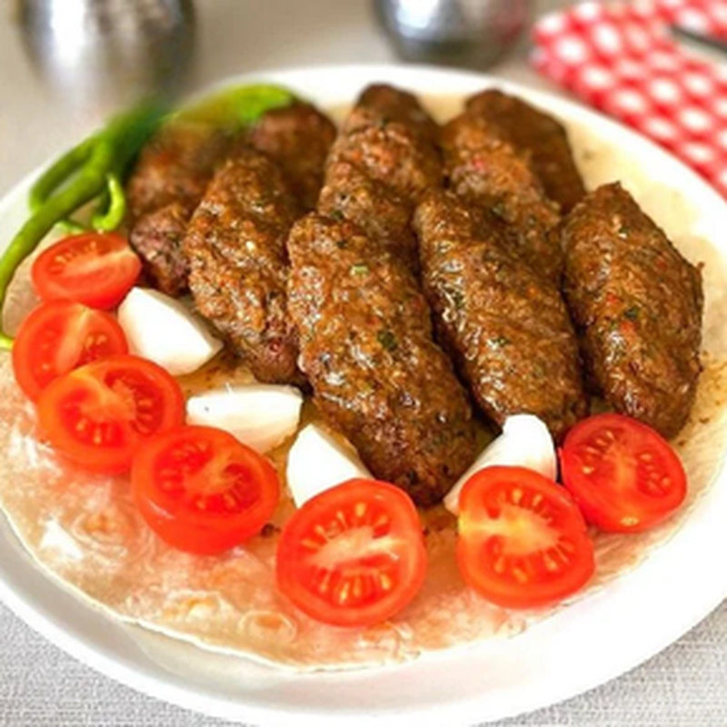 Beyti Köfte / Bulgur Pilavı — Garlicky grilled-style köfte with herbs, served over buttery bulgur pilaf.
